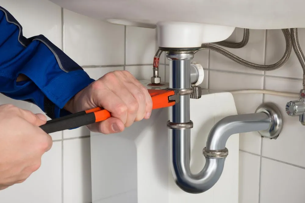 emergency plumber repairing sink pipe 1920w