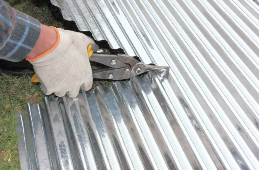 man cutting a metal roof for repairs 1920w