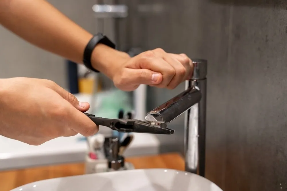 plumber installing a faucet 1920w